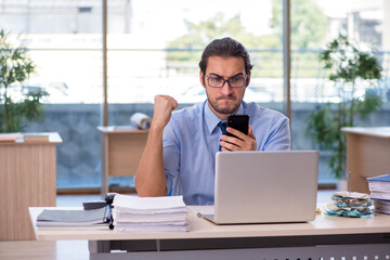 Young male accountant working in the office