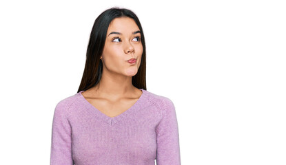 Fototapeta premium Young hispanic girl wearing casual clothes smiling looking to the side and staring away thinking.