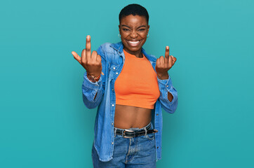 Young african american woman wearing casual clothes showing middle finger doing fuck you bad...