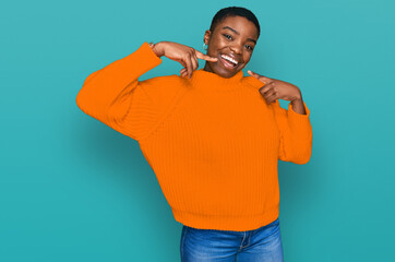 Young african american woman wearing casual clothes smiling cheerful showing and pointing with...