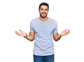 Young hispanic man wearing casual clothes smiling showing both hands open palms, presenting and advertising comparison and balance