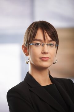 Portrait of serious young businesswoman in glasses.