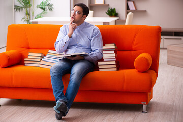 Young male student preparing for exams at home