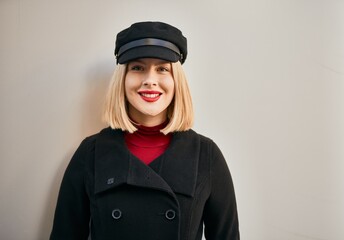 Young blonde woman smiling happy standing at the city.