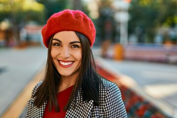 Young hispanic woman smiling happy standing at the city.