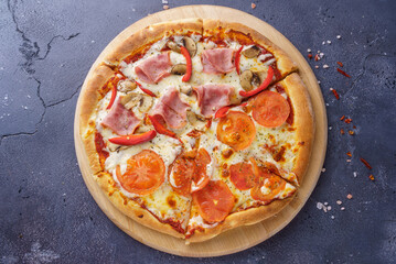 Pizza margarita and ham pizza together on the same board.