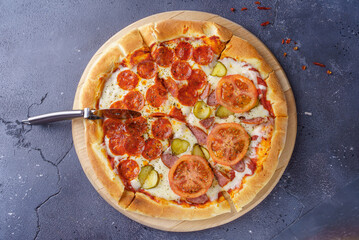 Pepperoni pizza and sausage pizza on the same board. In pizza pizza-knife