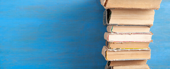 Old books on the blue wooden background.