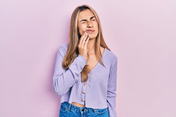 Beautiful hispanic woman wearing casual shirt touching mouth with hand with painful expression because of toothache or dental illness on teeth. dentist