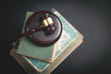 Judge gavel and book on the black background.