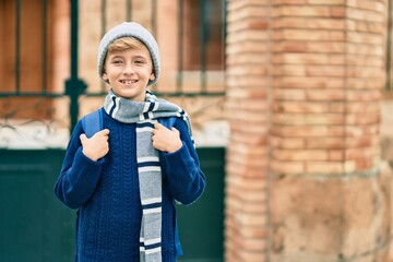 Adorable blond student kid smiling happy standing at the school.