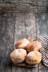 Traditional homemade doughnut with jam filling on wooden table