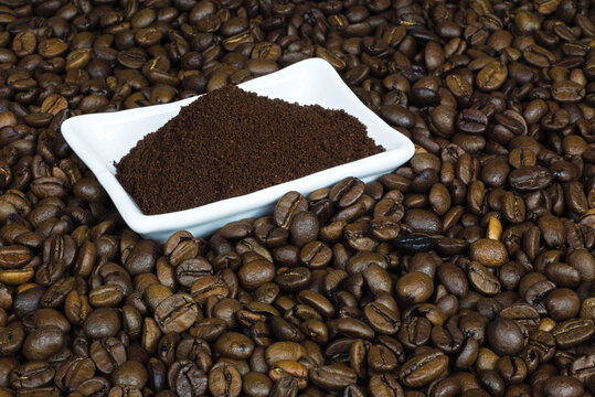 spilled coffee beans with a white bowl