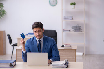 Fototapeta premium Young male employee sitting in the office