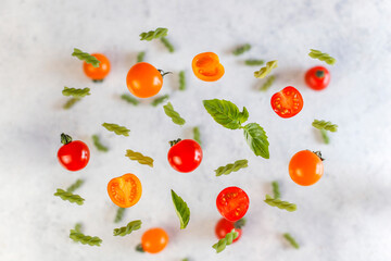 Delicious Italian caprese salad with sliced red and orange cherry tomatoes and mozzarela balls.