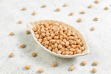 Uncooked dried chickpeas in a different glass jars and bowls.