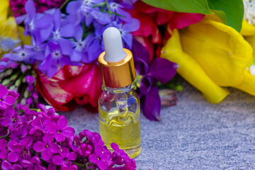 Flower Buzz Collection Flower essential oil. Lilac essential oil in a bottle. Selective focus