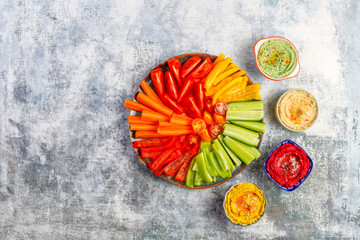 Colorful homemade various hummus bowls , green ,beet ,turmeric ,traditional hummus.