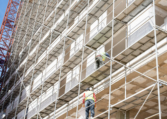 Construction workers on a scaffold.