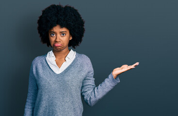 Young african american woman presenting with open palm depressed and worry for distress, crying angry and afraid. sad expression.