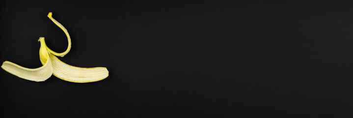 a yellow banana peel lies