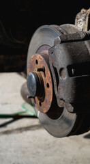 Car service and repair. Tire service. Repair of a broken wheel. Balancing. View of the car on the dock with the wheel removed.