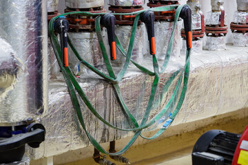 Drying lifting flat ropes in the boiler room on the valves.