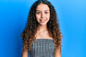 Teenager hispanic girl wearing casual clothes with a happy and cool smile on face. lucky person.