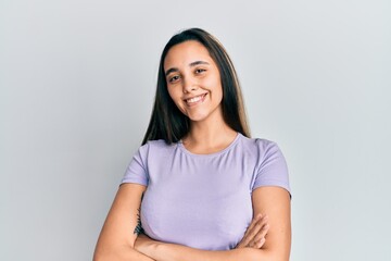 Young hispanic woman wearing casual clothes happy face smiling with crossed arms looking at the camera. positive person.