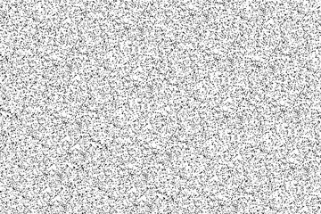 Many small black dots on a white surface