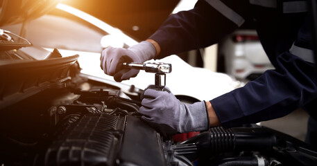 Auto mechanic working on car engine in mechanics garage.Repair service,car service, repair, maintenance concept.