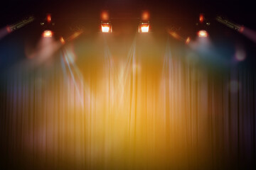 blurred empty theater stage with fun colourful spotlights, abstract image of concert lighting...