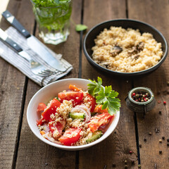 couscous salad tomato, cucumber, spices vegetable appetizer fresh portion organic on the table healthy meal snack copy space food background rustic top view 
