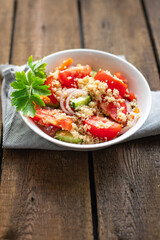 couscous salad tomato, cucumber, spices vegetable appetizer fresh portion organic on the table healthy meal snack copy space food background rustic top view 