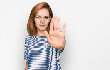 Young caucasian woman wearing casual clothes doing stop sing with palm of the hand. warning...