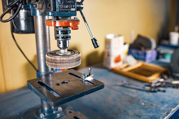 Drilling machine at the workplace in workshop
