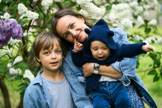 happy mother and son in the garden of blooming lilacs. High quality photo