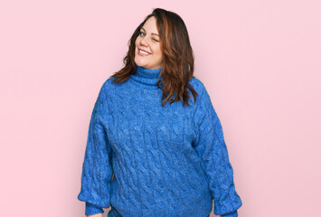 Young plus size woman wearing casual clothes winking looking at the camera with sexy expression,...