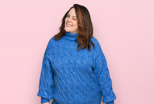 Young plus size woman wearing casual clothes winking looking at the camera with sexy expression, cheerful and happy face.