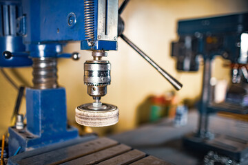 Drilling machine at the workplace in workshop