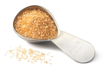 yellow sugar in the metal measuring spoon, isolated on white background