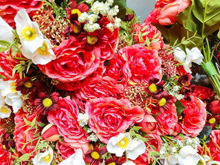 Bright and beautiful multi colors of plastic fake leaves and flowers background for home interior decoration