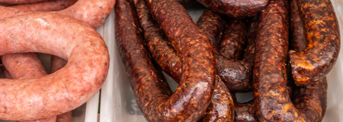 Typical Spanish sausages lying on a village stall at the food market