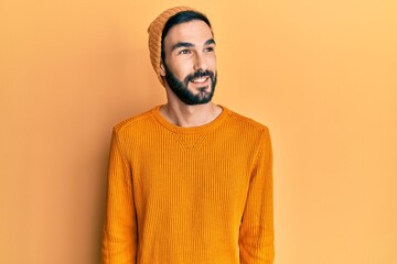Obraz premium Young hispanic man wearing casual clothes looking to side, relax profile pose with natural face and confident smile.