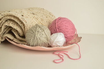 pink and white woolen balls with woolen scarf