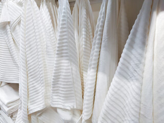 Fototapeta na wymiar many pile of rolled towels for sale in housewares shop.