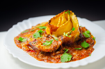 Hand rolled four cheese ravioli pasta in minced beef with Chianti red wine, garlic and herb ragu, and a bechamel sauce topped with pecorino cheese crumb and finished with fresh parsley