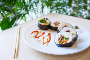  tuna Sushi on plate with chopstick on table 
