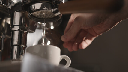 closeup of rinsing espresso coffee machine in the morning
