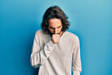 Young hispanic man wearing casual clothes feeling unwell and coughing as symptom for cold or bronchitis. health care concept.